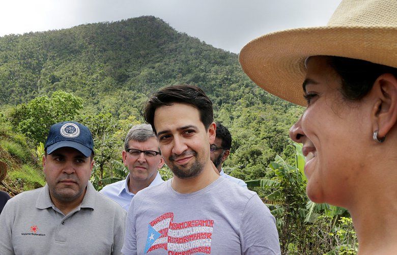 Coffee farmer Vanessa Arroyo, Lin-Manuel Miranda, midle, and Jose Calderon, left, President of the Hispanic Federation, react during a walking tour in Jayuya, where they made an announcement related to supporting the island’s coffee industry on October 24, 2018. (Pedro Portal/Miami Herald/TNS) 1243578 1243578