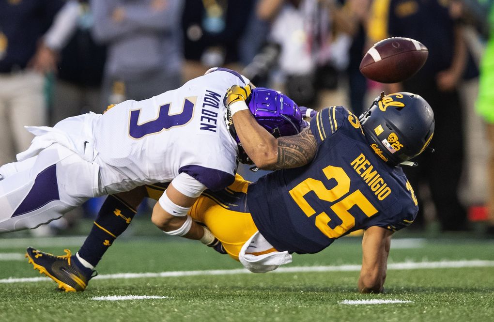 On 3rd and 5 from the Bear 11-yard line, Washington’s Elijah Molden lays a hit on Cal receiver Nikko Remigio that dislodges the ball, and forces a punt with 11:45 to play in the game. (Dean Rutz / The Seattle Times)