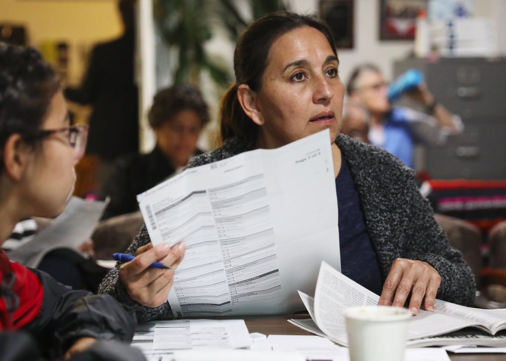 Voter Oralia Banuelos brought her ballot and 13-year-old daughter, at left, to a Latino voter-education event, where they learned about a mid-term ballot for the first time. Banuelos said she had only voted in presidential elections until now. (Ken Lambert / The Seattle Times)