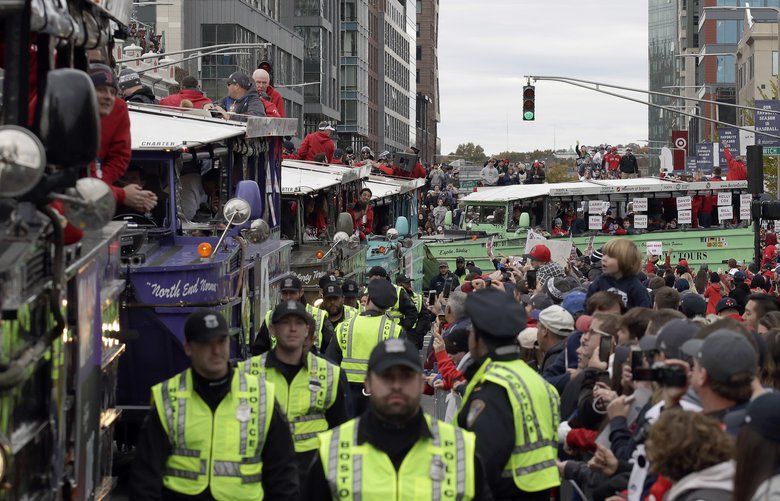 Parade fetes Red Sox; trophy, manager Cora hit by beer cans