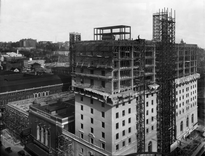 <strong>THEN:</strong> An instance in the 1924 construction of the Olympia Hotel recorded from the roof of the Cobb Building. Included, upper left, among the First Hill landmarks are, on the horizon at Madison Street and Terry Avenue, the Sorrento Hotel and, far left, the brilliant terra-cotta-clad Fourth Christian Science Church, now Town Hall, at Eighth and Seneca. (Courtesy Museum of History & Industry)