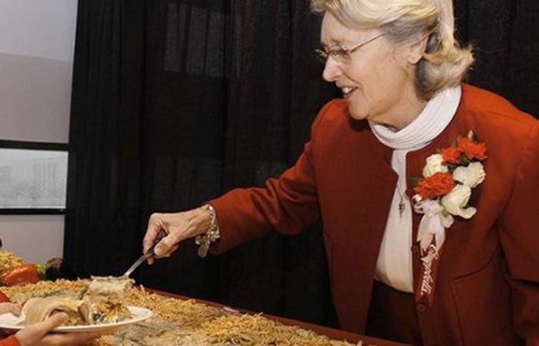 Dorcas Reilly, inventor of the Campbell’s Soup Green Bean casserole serves a helping of the casserole. (Courtesy of Campbell Soup via AP)