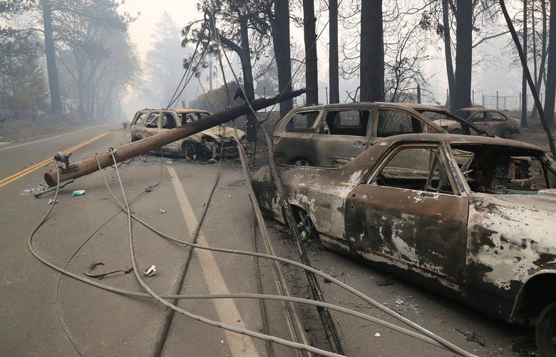 Burned cars and downed power lines in the aftermath of the wildfires in Paradise, Calif., Nov. 10, 2018. (Jim Wilson/The New York Times) XNYT157 XNYT157