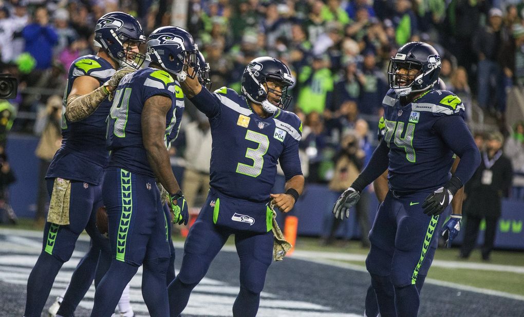 Seattle Seahawks quarterback Russell Wilson and Seattle Seahawks offensive tackle George Fant, right, celebrate Seattle Seahawks tight end Ed Dickson fourth quarter touchdown. (Mike Siegel / The Seattle Times)