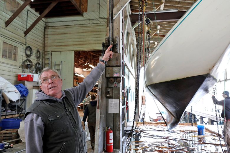 At Jensen Motor Boat Company, yard manager Peter Proctor will continue to be on hand until the sale is completed.  
At right, a wooden sailboat is hauled and cleaned before getting new paint on the hull. (Greg Gilbert / The Seattle Times)