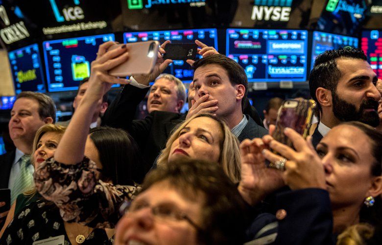 People on the floor of the New York Stock Exchange moments before the closing bell, Nov. 20, 2018. The stock market’s gains for 2018 were erased on Tuesday, as a sell-off led by giant technology stocks continued. The renewed declines in the United States came after drops in Asia and Europe. (Hilary Swift/The New York Times) 