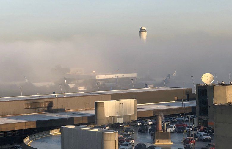 A thick blanket of fog descended over the Seattle area Tuesday morning Nov. 20, 2018, delaying flights at Sea-Tac Airport and forcing diversions of landing aircraft ahead of one of the busiest travel weekends of the year.