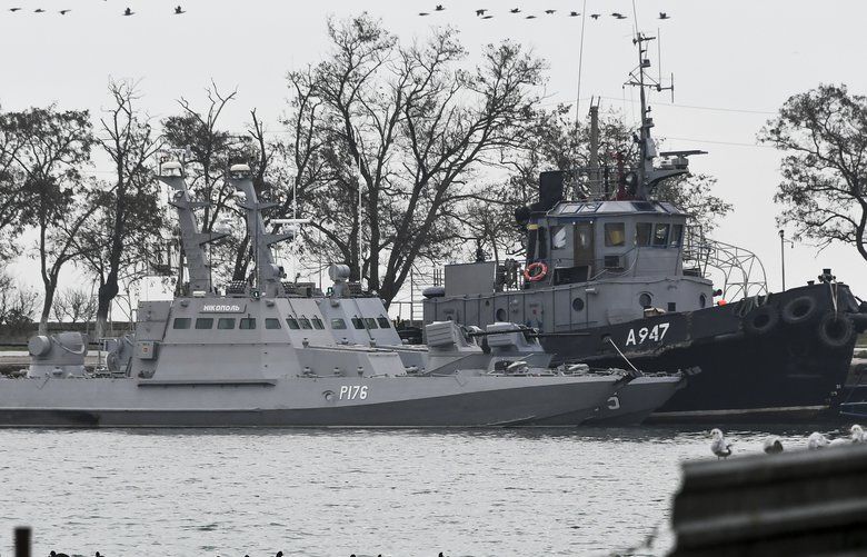 Three Ukrainian ships are seen as they docked after been seized ate Sunday, Nov. 25, 2018, in Kerch, Crimea, Monday, Nov. 26, 2018. The Ukrainian parliament is set to consider a presidential request for the introduction of martial law in Ukraine following an incident in which Russian coast guard ships fired on Ukrainian navy vessels. (AP Photo) XAZ103 XAZ103
