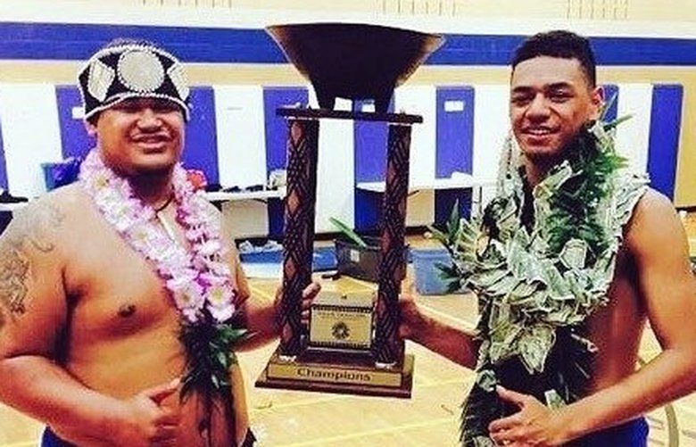Leuea Loto and Jersiah Tafia hold the champion trophy at the inaugural Samoan Arts and Academics Competition in 2015.