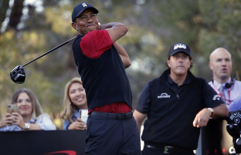 Tiger Woods hits off the 16th tee as Phil Mickelson watches during a golf match at Shadow Creek golf course, Friday, Nov. 23, 2018, in Las Vegas. (AP Photo/John Locher) NVJL126 NVJL126
