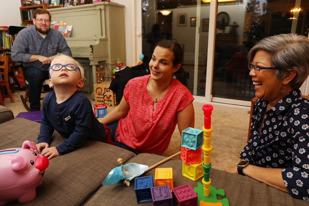 Elda Harada, right, visits Arthur every week at mom Keren and dad Jonathan Marzinke’s home in Sammamish. Arthur was diagnosed with tuberous sclerosis complex. (Ken Lambert / The Seattle Times)