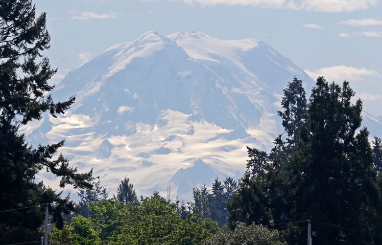 The contours of Mount Rainier are visible under a partly cloudy sky, Monday, May 2, 2016, as viewed from Fort Steilacoom Park in Lakewood, Wash. Temperatures were approaching 80 across most of Western Washington Monday. (AP Photo/Ted S. Warren)