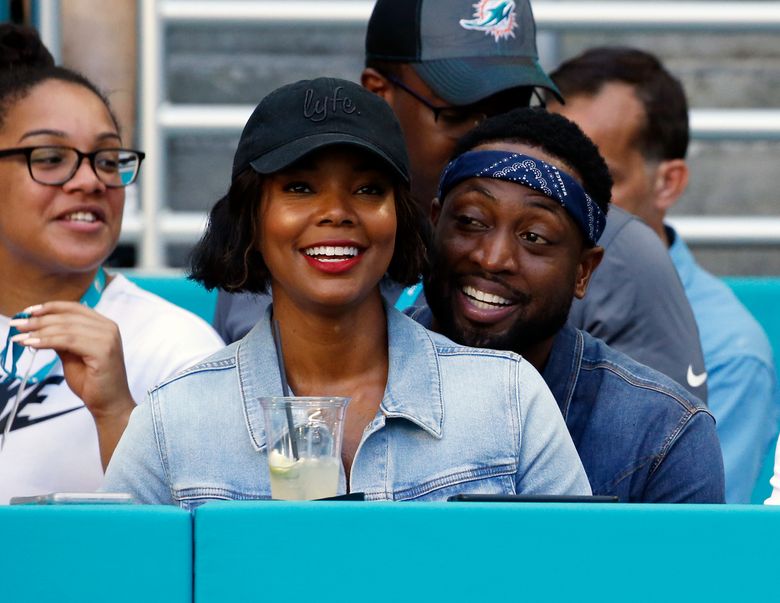 Dwyane Wade, Gabrielle Union, and Kaavia at Miami Heat Game