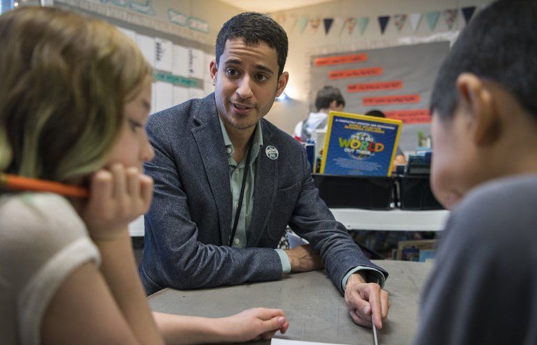 Adam Aguilera helps fourth-graders with a math game during class at Pioneer Elementary School on Nov. 5 in Vancouver. Aguilera leads cultural responsiveness training for other teachers rooted in the idea that teachers need to be aware of and respect teachers’ diverse backgrounds. 
(Alisha Jucevic/The Columbian)