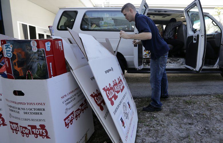 Stf. Sgt. Brian Spittler loads a vehicle with toy donations at the Marine Corps Toys for Tots depot, Wednesday, Dec. 19, 2018, in Hialeah, Fla. The recent closure of Toys R Us created some collateral damage — the Toys for Tots charity drive. More than 250,000 toys donated by consumers and $5 million, 40 percent of corporate giving, came through Toy R Us last year, holes the annual Marine Corps’ community effort is working to fill. (AP Photo/Lynne Sladky) FLLS202 FLLS202