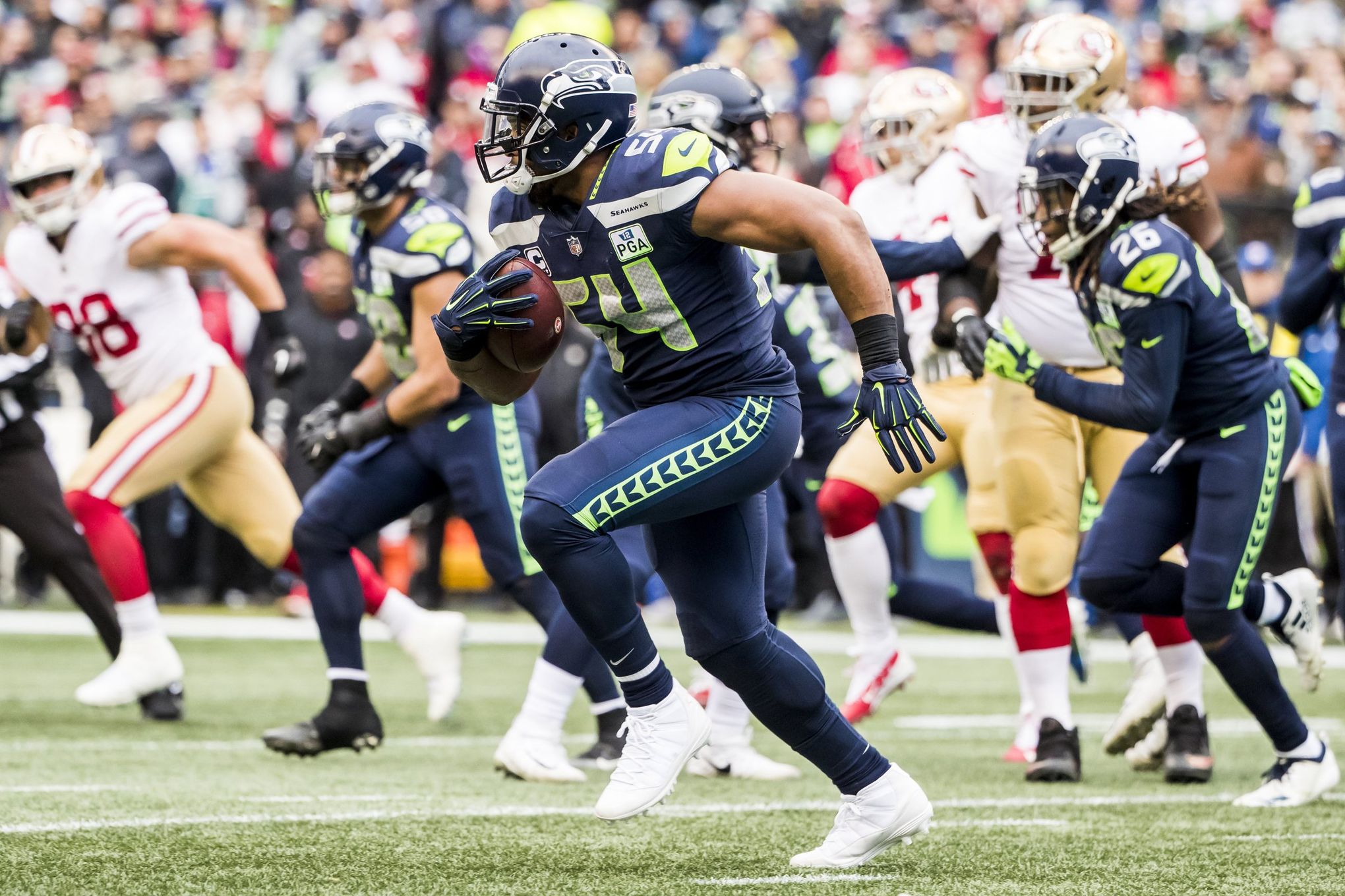 Seattle Seahawks strong safety Kam Chancellor (31) and linebacker Bobby  Wagner (54) wrap up San Francisco 49ers tight end Vernon David (85) during  the NFL Championship Game at CenturyLink Field in Seattle