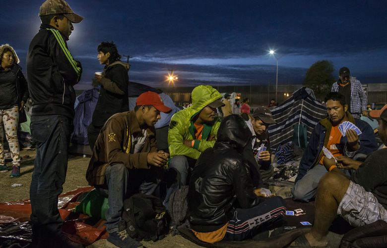 Migrants play cards in a sports center turned into a shelter in Tijuana, Mexico, Nov. 21, 2018. The Tijuana crisis is putting pressure on Mexico’s relationships with Central America, from which most of the gathered migrants are from, and the United States, where most are headed. (Mauricio Lima/The New York Times)