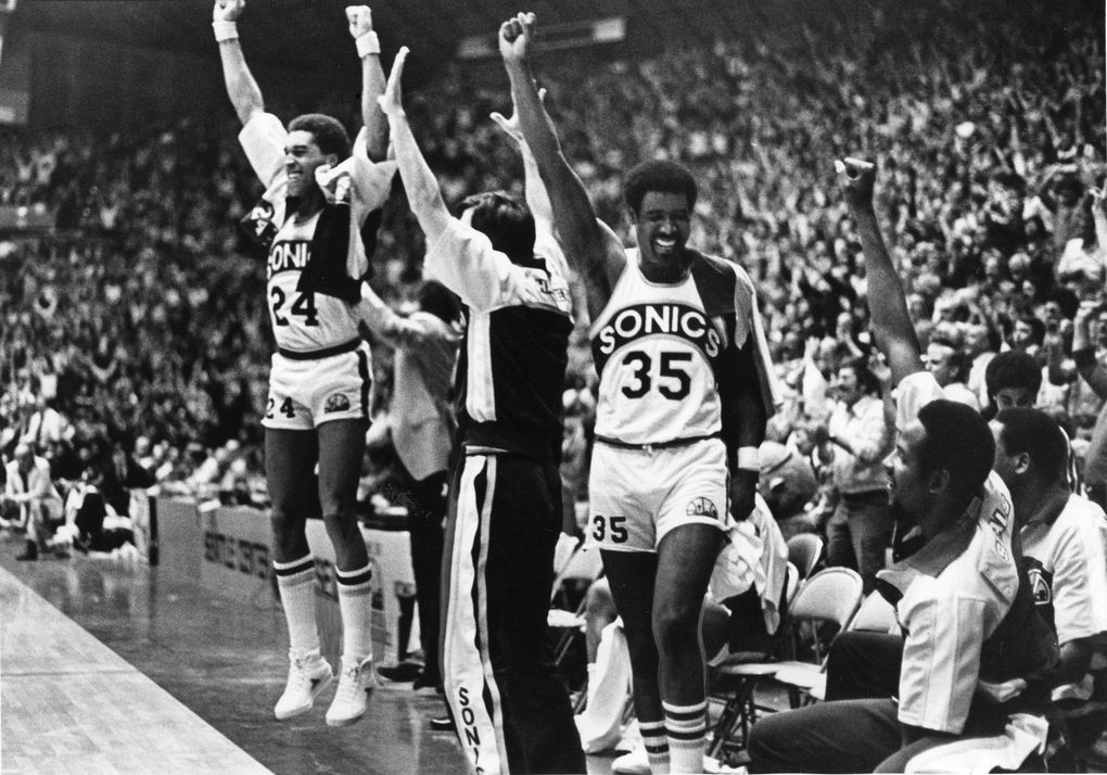 Jubilant SuperSonics raise their arms in a victorious salute near the end of their series-clinching playoff win over Portland on May 2, 1978. (Larry Dion / The Seattle Times)