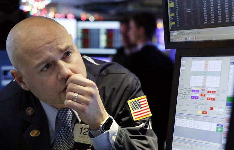 Specialist Mario Picone, center, works on the floor of the New York Stock Exchange. The U.S. stock market opens at 9:30 a.m. EST on Thursday, Jan. 3. (AP Photo/Richard Drew, File) 