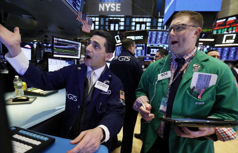 Specialist Peter Mazza, left, and trader Ryan Falvey work on the floor of the New York Stock Exchange, Thursday, Jan. 10, 2019. Stocks are slumping in early trading on Wall Street led by steep drops in Macy’s and other retailers after several of the companies reported weak holiday sales. (AP Photo/Richard Drew) 