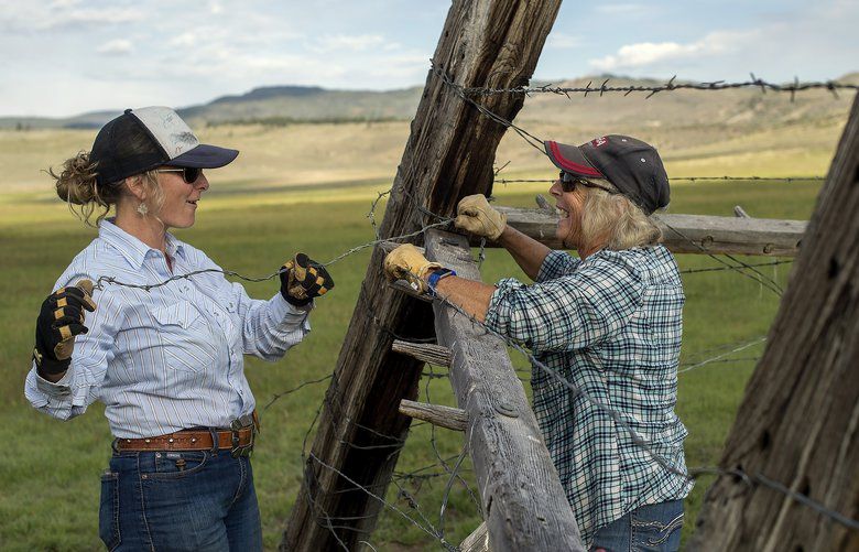 Caitlyn Taussig and her mother, Vicki, mend fences on their ranch in Kremmling, Colo., Aug. 11, 2017. Against the vast blue skies and craggy prairies, female ranchers have found the same independence and adventure that first lured their male antecedents, but they are also forging a new path. (Amanda Lucier/The New York Times)
 XNYT61 XNYT61