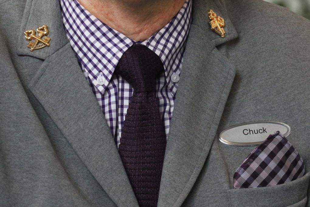 The gold key pins on Chuck Watts’ lapels signify his membership in Les Clefs d’Or, the national organization of hotel-lobby concierges. Watts received his keys in 2007. (Alan Berner / The Seattle Times)