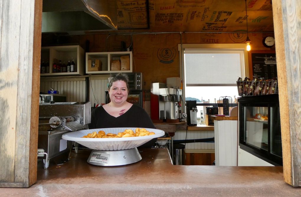 Katie Millsap tempts ferry passengers with mini-doughnuts at Aviator Coffee near the Kingston ferry dock. (Carol Pucci / Special to The Seattle Times)