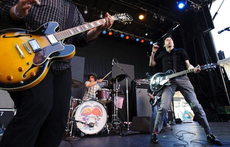 (left to right) Jon Auer CQ,  Darius Minwalla CQ, and Ken Stringfellow CQ of The Posies perform on the main stage at the Capitol Hill Block Party in Seattle on Sunday, July 24, 2011.