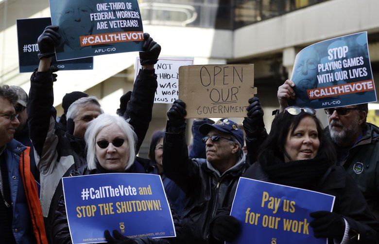 Federal workers rally Friday at the Philadelphia International Airport. (Matt Slocum / AP)