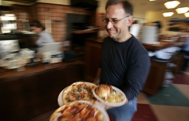 SETS OF IMAGES FOR NANCY LESON FOOD RETROSPECTIVE – LE PICHET (CAFFE VITA), MIOPOSTO, CENTRAL MARKET SUSHI  – 58368 –  032406

Jeremy Hardy (cq) serves an order at Mioposto, a newly-opened pizzeria in Mount Baker he co-owns with his business partner Peter Levy. Restauranteurs together for 18 years, they have 6 community restaurants in their stable of businesses.