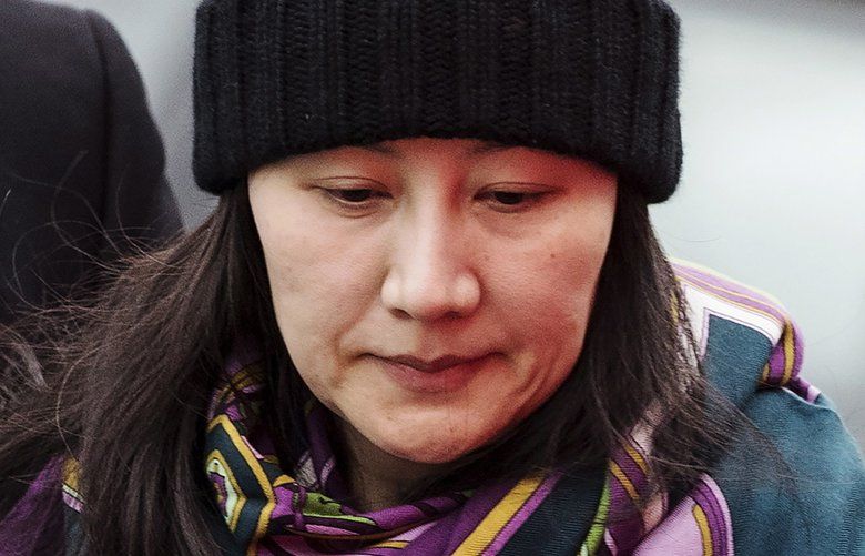 FILE – In this Dec. 12, 2018, file photo, Huawei chief financial officer Meng Wanzhou arrives at a parole office with a security guard in Vancouver, British Columbia. China on Tuesday, Jan. 22, 2019, demanded the U.S. drop a request that Canada extradite the top executive of the tech giant Huawei, shifting blame to Washington in a case that has severely damaged Beijing’s relations with Ottawa. (Darryl Dyck/The Canadian Press via AP, File)