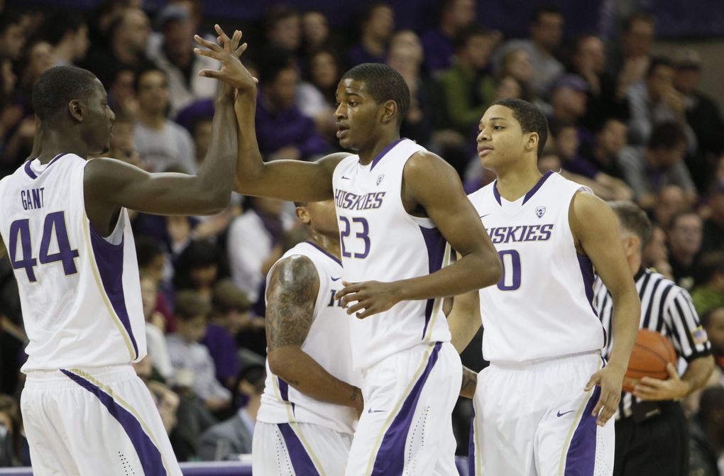 Washington’s Darnell Gant (44) and Isaiah Thomas (2) greet C.J. Wilcox (23) and Abdul Gaddy (0) as they come off the floor during a timeout in the second half at Hec Edmundson Pavilion in Seattle, WA, Wednesday, December 22, 2010.
(Jim Bates / The Seattle Times)