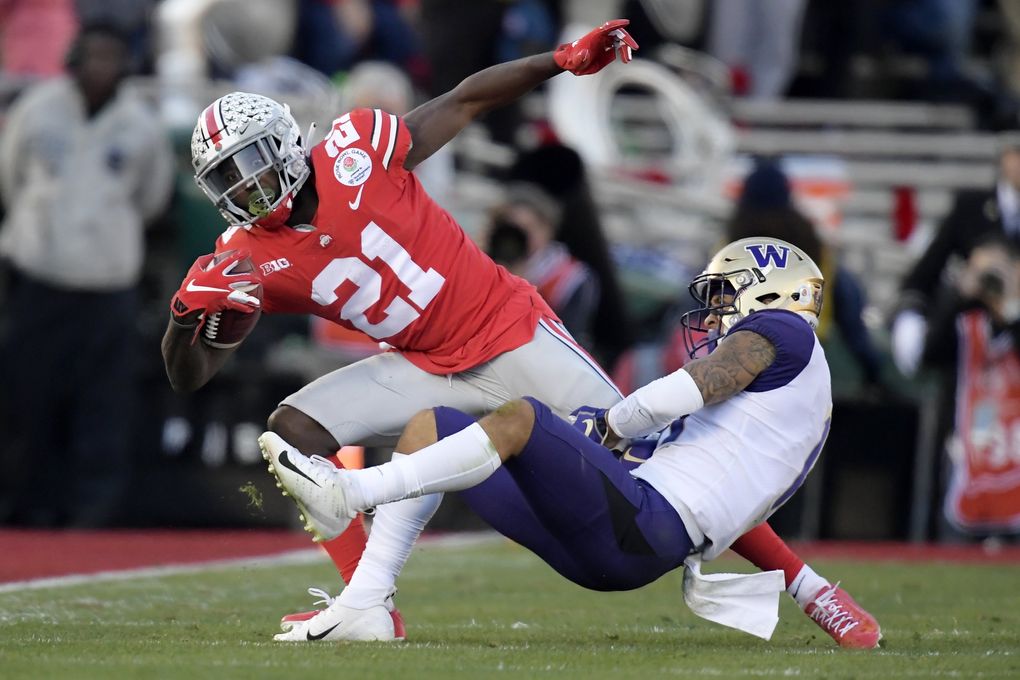 Ohio State wide receiver Parris Campbell is tackled by Washington defensive back Brandon McKinney in the Rose Bowl on Tuesday. (Mark J. Terrill / The Associated Press)