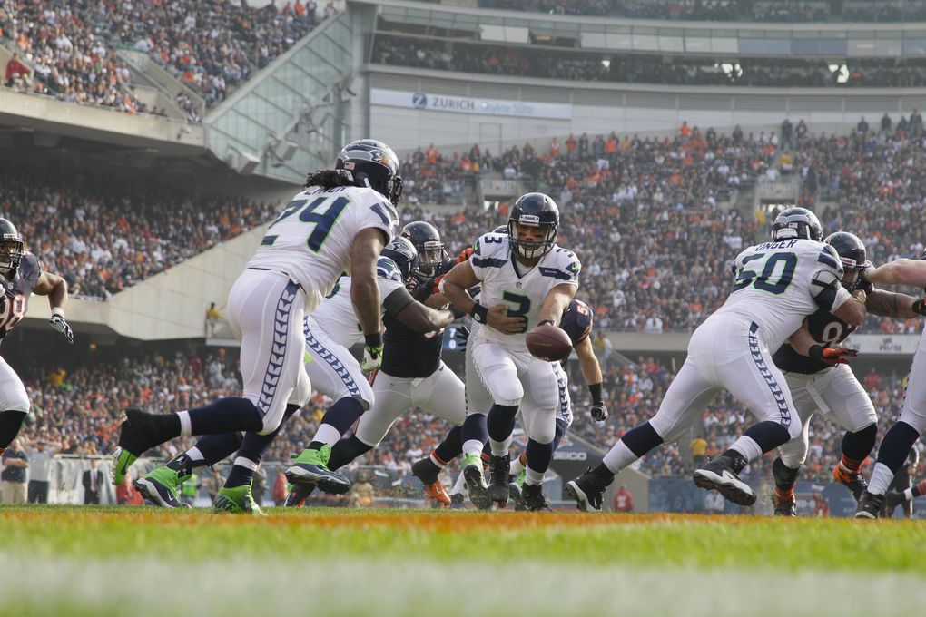 Seattle Seahawks quarterback Russell Wilson (3) hands off to running back Marshawn Lynch (24) in the first half of an NFL football game in Chicago, Sunday, Dec. 2, 2012. (Nam Y. Huh / The Associated Press)
