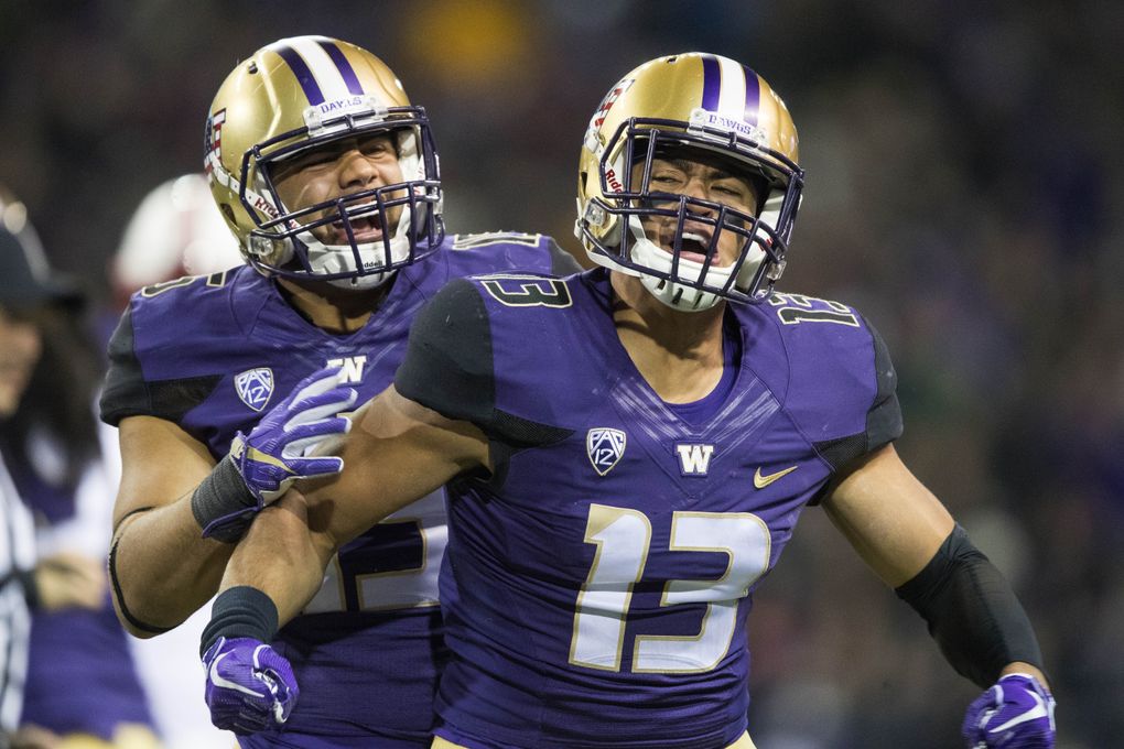Linebackers Brandon Wellington (13) and DJ Beavers celebrate in 2017. (Dean Rutz/The Seattle Times, file)