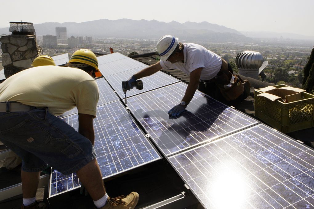 <strong>SOLAR ENERGY: </strong>In this March 23, 2010, file photo, installers from California Green Design install solar electrical panels on the roof of a home in Glendale. (Reed Saxon / The Associated Press, file)