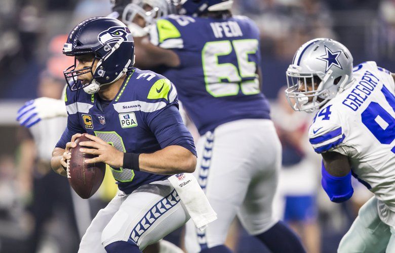 Dallas Cowboys wide receiver Amari Cooper (19) sheds a tackle by Seattle  Seahawks safety Tedric Thompson (33) during the first quarter in an NFL  Wild Card playoff game at AT&T Stadium in