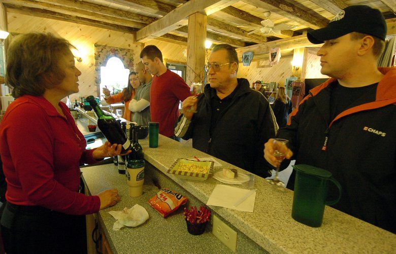 Stanley Robinson, center, and his son John Robinson, right, taste wines with the help of manager Joanne Lachance at the Linganore Winecellars in Mount Airy, Md., in 2006. Industry-wide, tasting-room visits are down at wineries. MUST CREDIT: Washington Post photo by Ricky Carioti.