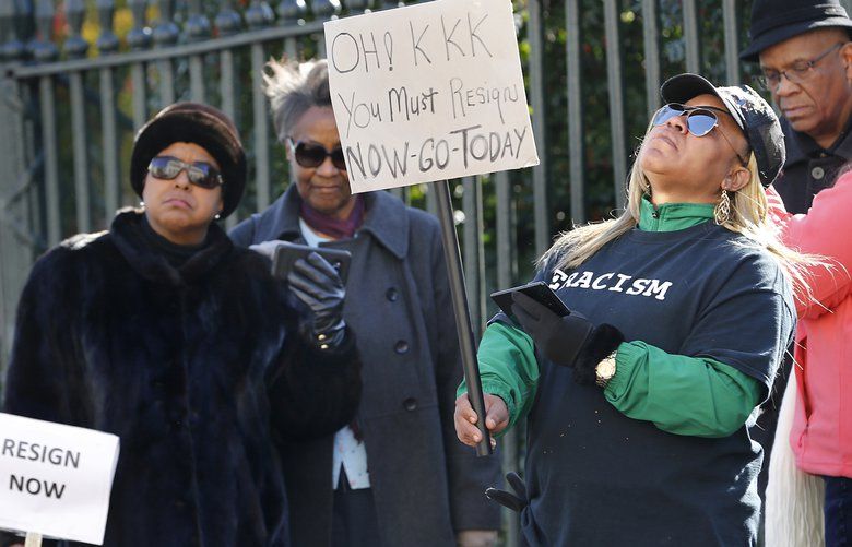 Tara Raigns, of Petersburg, Va., right, reacts to Gov. Ralph Northam’s comments during a news conference in the Governor’s Mansion in Richmond, Va., on Saturday, Feb. 2, 2019. She joined protesters outside, calling for his resignation. (Alexa Welch Edlund/Richmond Times-Dispatch via AP) VARIT201 VARIT201