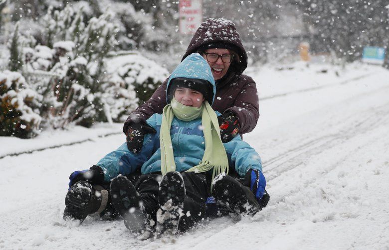 Harper Luthi, 11, and his mother Hilary Luthi sled near their home in West Seattle Friday, Feb. 8, 2019.