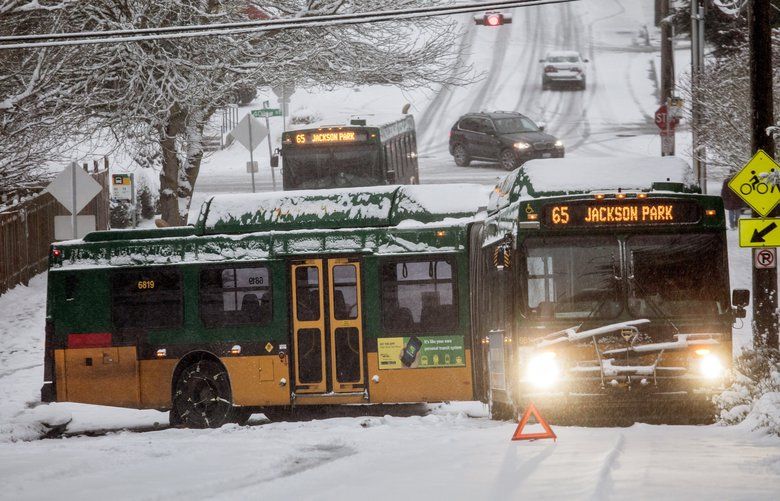 Monday, Feb. 4, 2019.  A Metro bus is jackknifed as it tried to go up NE 55th Street on the slick road with compressed snow.   209226 209226