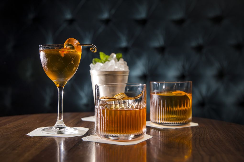 Deep Dive’s cocktails include, clockwise from front, Choose Your Own Adventure, Trust Us, Iron Curtain, and Rich and Famous. (Bettina Hansen / The Seattle Times)
