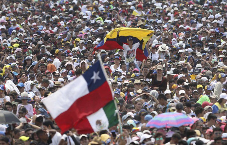 Concert goers enjoy the performances during the Venezuela Aid Live concert on the Colombian side of Tienditas International Bridge near Cucuta, Colombia, on the border with Venezuela, Friday, Feb. 22, 2019. (AP Photo/Fernando Vergara) COFV149 COFV149
