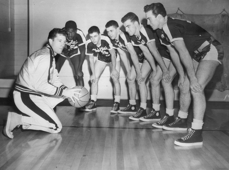 Sophomore Hopefuls: Al Brightman, Seattle University basketball mentor, huddled with five members of the freshman squad in 1949. From left – Brightman, Oscar Holden, Ed O’ Brien, Johnny O’ Brien, Jerry Vaughan and Jack Doherty. (Vic Condiotty / The Seattle Times)