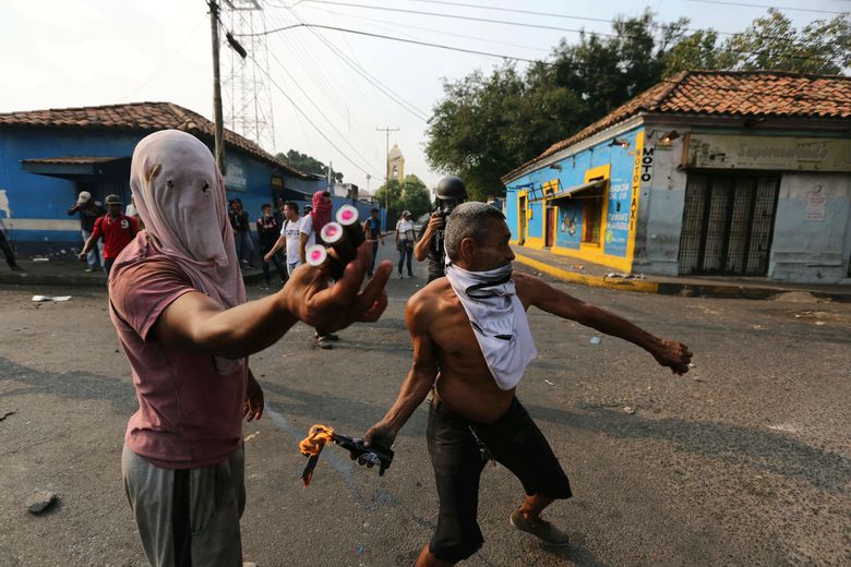 Opposition demonstrators clash with the Bolivarian National Guard in Urena, Venezuela, near the border with Colombia, Saturday, Feb. 23, 2019. Venezuela’s National Guard fired tear gas on residents clearing a barricaded border bridge between Venezuela and Colombia on Saturday, heightening tensions over blocked humanitarian aid that opposition leader Juan Guaido has vowed to bring into the country over objections from President Nicolas Maduro(AP Photo/Fernando Llano)