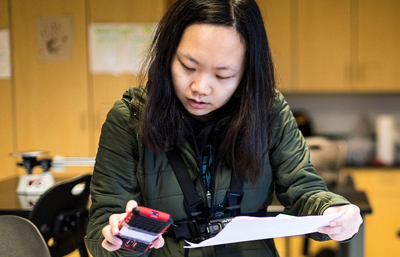 Yini Guan, a Master of Science in Information Management student at the University of Washington Information School, gathers data for a research project. Researchers at the school are studying whether a mobile application can forge a connection between children and the outdoors. (Courtesy of Mark Stone / University of Washington)