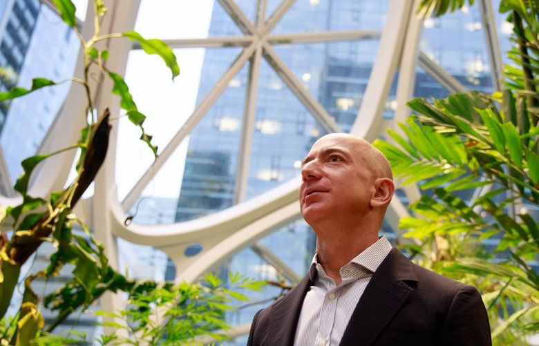 Jeff Bezos, center, tours The Spheres at Amazon’­s campus in downtown Seattle Monday, Jan. 29, 2018. The Spheres house more than 40,000 plants, and features waterfalls, fish tanks and 40-foot trees. 

