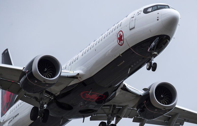 An Air Canada Boeing 737 MAX 8 aircraft arriving from Toronto prepares to land at Vancouver International Airport in Richmond, B.C., on Tuesday. Canadian Transport Minister Marc Garneau grounded the MAX Wednesday. (Darryl Dyck/The Canadian Press via AP) 