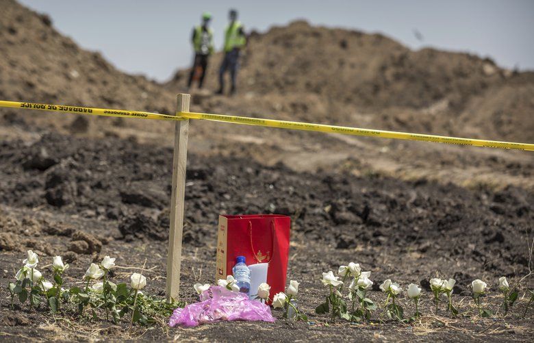 Flowers are left at the scene where the Ethiopian Airlines Boeing 737 Max 8 plane crashed shortly after takeoff on Sunday killing all 157 on board, near Bishoftu, south of Addis Ababa, in Ethiopia Wednesday, March 13, 2019.  The black box from the Boeing jet that crashed will be sent overseas for analysis but no country has been chosen yet, an Ethiopian Airlines spokesman said Wednesday, as much of the world grounded or barred the plane model and grieving families arrived at the disaster site. (AP Photo/Mulugeta Ayene) AAS103 AAS103