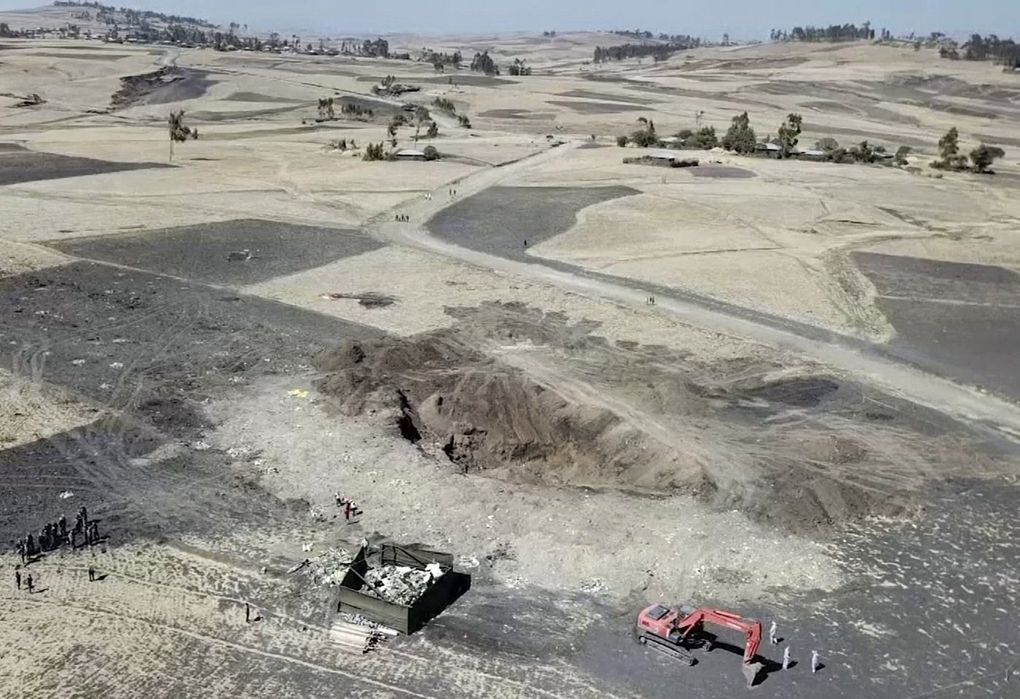 Recovery work continues around the crater where the Ethiopian Airlines plane crashed shortly after takeoff last week near Bishoftu, southeast of Addis Ababa. Flight data analysis is yielding clues about the cause of the crash. (Yidnek Kirubel / The Associated Press)